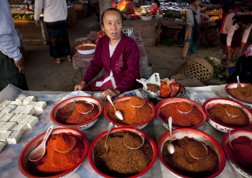 Woman selling powders in a market, Muang sing, Laos