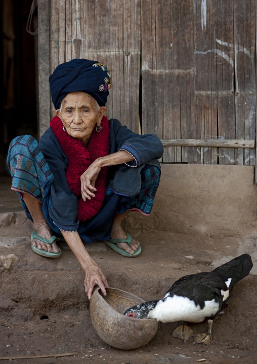Yao minority old woman feeding ducks, Ban xay leck, Laos
