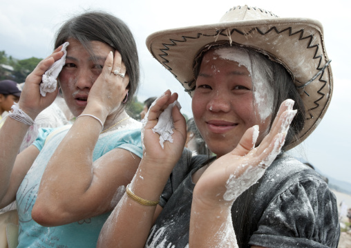 Girls with flour on the face during pii mai lao new year celebration, Luang prabang, Laos