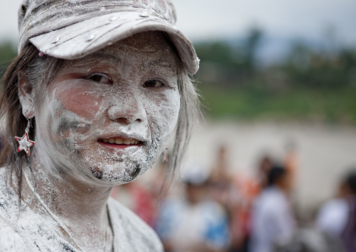 Woman with flour on the face during pii mai lao new year celebration, Luang prabang, Laos