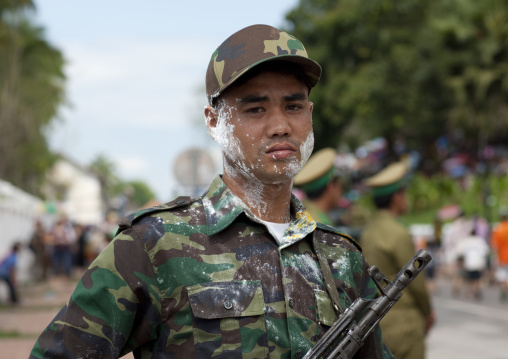 Soldier with flour on the face during pii mai lao new year celebration, Luang prabang, Laos