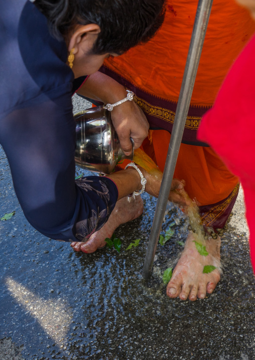 Woman Putting Fresh Water On The Feet Of An Hindu Devotee In Annual Thaipusam Religious Festival In Batu Caves, Southeast Asia, Kuala Lumpur, Malaysia