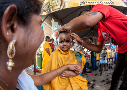 Child Being Shaved With A Razor In Annual Thaipusam Religious Festival In Batu Caves, Southeast Asia, Kuala Lumpur, Malaysia