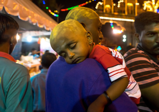 Portrait Of A Child Sleeping On His Father Shoulder In Batu Caves In Annual Thaipusam Religious Festival, Southeast Asia, Kuala Lumpur, Malaysia