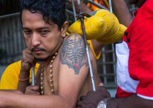 Tired Hindu Devotee With Tattoo On His Shoulder In Annual Thaipusam Religious Festival In Batu Caves, Southeast Asia, Kuala Lumpur, Malaysia