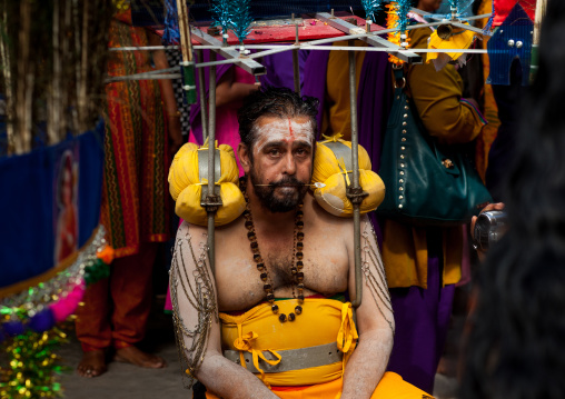 Hindu Devotee In Annual Thaipusam Religious Festival In Batu Caves Resting With His Kavadi On The Shoulders, Southeast Asia, Kuala Lumpur, Malaysia