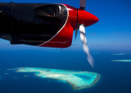 Maldivian Air Taxi Seaplane Flying Over An Atoll, Male, Maldives
