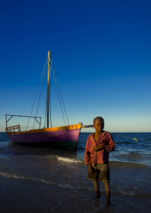 Kid In Front Of A Dhow On The Beach, Vilanculos, Inhambane province, Mozambique
