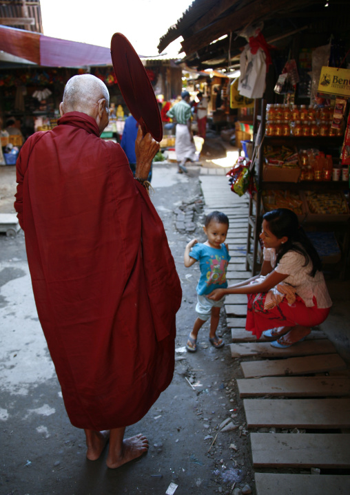 Monk Blessing A Kid In A Street, Ngapali, Myanmar