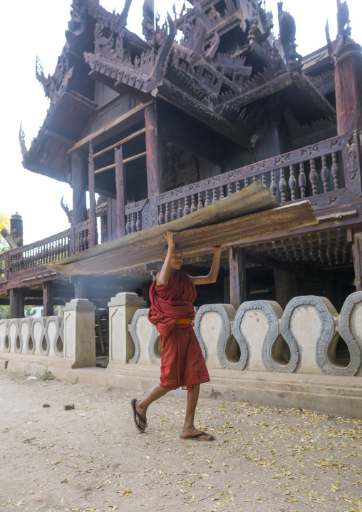 Novice Monk In Nat Taung Kyaung Monastery Carrying Furniture, Bagan, Myanmar