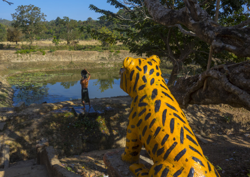 Man Taking A Bath In A Lake In Front Of A Tiger Statue In A Monastery, Mrauk U, Myanmar