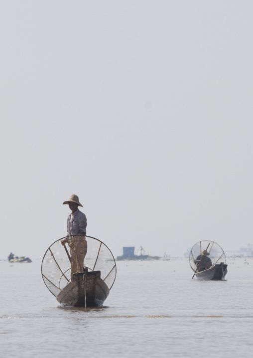 Traditional Fisherman With Fish Trap In Boat, Inle Lake, Myanmar