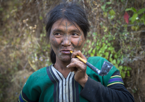 Tribal Chin Woman From Muun Tribe With Tattoo On The Face Smoking, Mindat, Myanmar