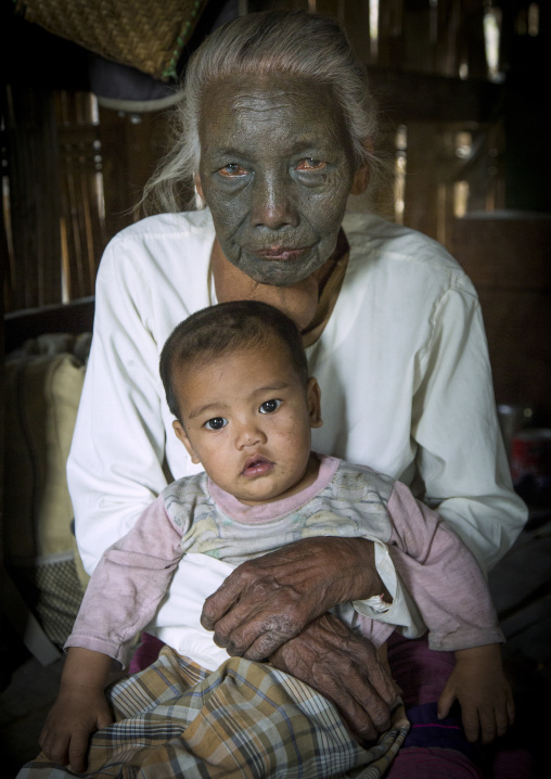 Tribal Chin Woman From U Pu Tribe With Tattoo On The Face Holding Her Little Son, Kanpelet, Myanmar