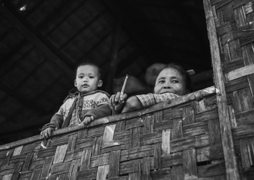 Mother And Her Child Looking Over A Window In A Bamboo House, Ngapali, Myanmar