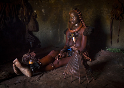 Himba Woman Using Incense To Purify Herself And Her Clothes, Epupa, Namibia