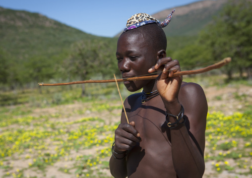 Himba Man Playing Bow Instrument, Epupa, Namibia