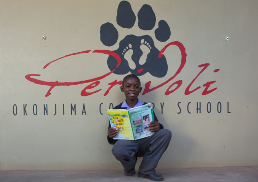 Boy Reading A Book At Africat Foundation, Okonjima, Namibia