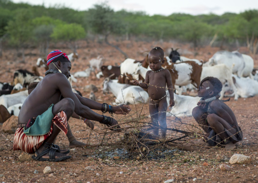 Himba Family In Front Of The Sacred Fire, Epupa, Namibia