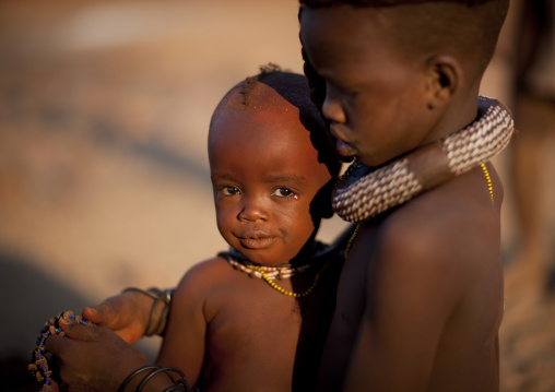 Himba Girl Taking Care Of Her Little Brother Sister