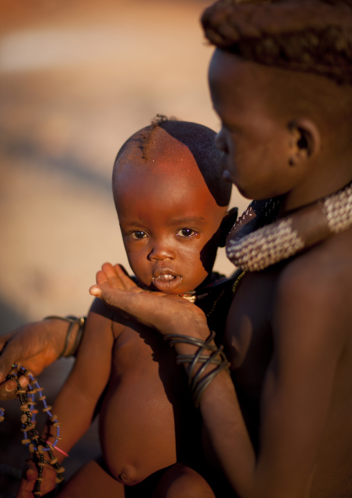 Himba Girl Taking Care Of Her Little Brother Sister