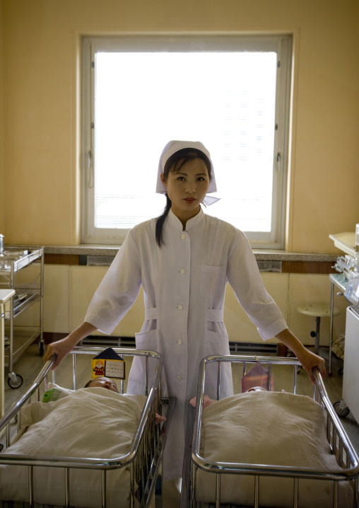 North Korean nurse with newborn babies in a maternity, Pyongan Province, Pyongyang, North Korea