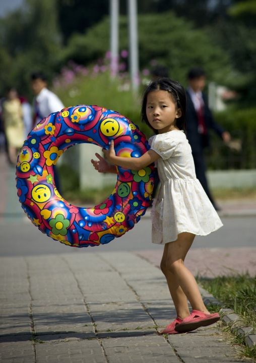North Korean girl with a rubber ring in the street, Pyongan Province, Pyongyang, North Korea