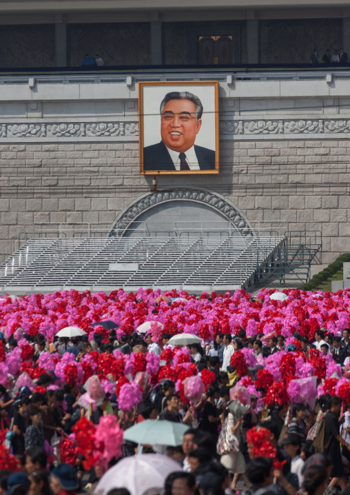 North Korean people with plastic bunches of red flowers celebrating the 60th anniversary of the regim, Pyongan Province, Pyongyang, North Korea
