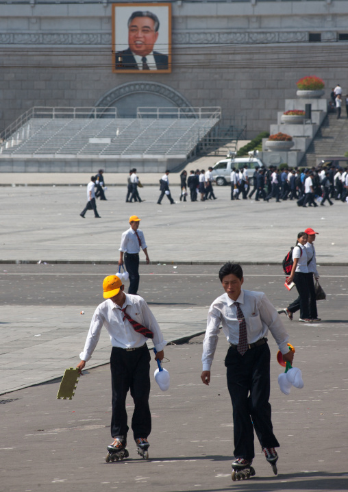 North Korean boys with rollers on Kim il Sung square, Pyongan Province, Pyongyang, North Korea