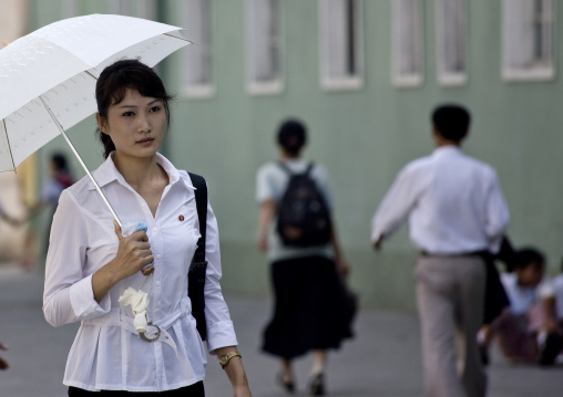 Beautiful North Korean woman with an umbrella in the street, Pyongan Province, Pyongyang, North Korea