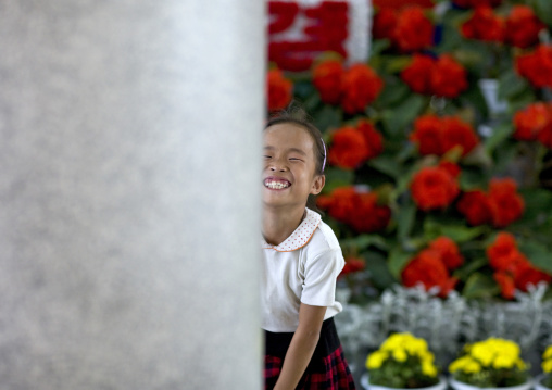 North Korean girl laughing in the international Kimilsungia and Kimjongilia festival, Pyongan Province, Pyongyang, North Korea