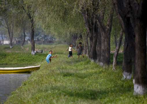 North Korean boys playing on the banks of a lake, North Hwanghae Province, Sariwon, North Korea