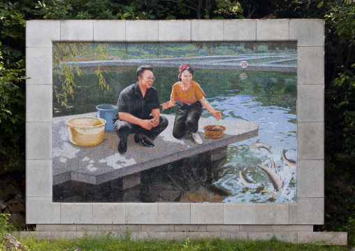 Farm fish mosaic fresco with Kim Jong il and a female worker in front of a pound, North Hwanghae Province, Sariwon, North Korea