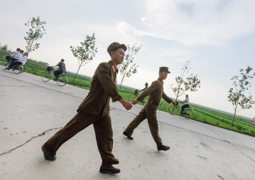 North Korean soldiers walking on a road in the countryside, Kangwon Province, Chonsam Cooperative Farm, North Korea