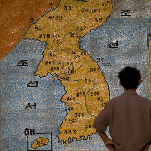 North Korean man looking a Korea map in the street, North Hwanghae Province, Sariwon, North Korea