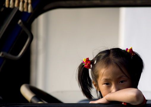 North Korean girl looking thru a truck window, North Hwanghae Province, Sariwon, North Korea