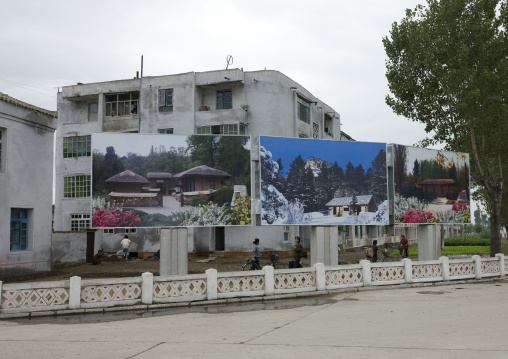 Pictures of the native houses the Dear Leaders on a propaganda billboard, North Hwanghae Province, Kaesong, North Korea