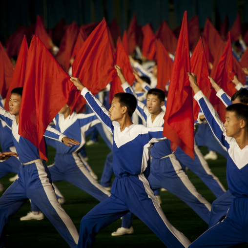 North Korean gymnasts with red flags during the Arirang mass games in may day stadium, Pyongan Province, Pyongyang, North Korea