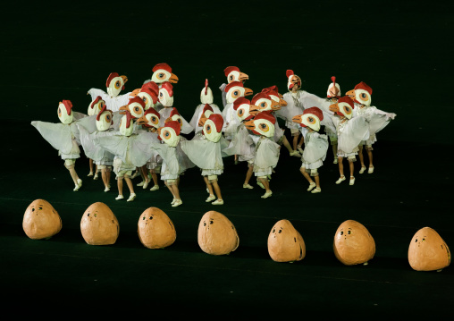 North Korean people dressed as chickens in front of giant eggs during the Arirang mass games in may day stadium, Pyongan Province, Pyongyang, North Korea
