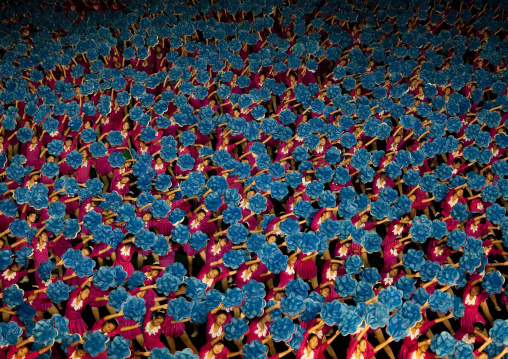 North Korean gymnasts holiding blue flowers during Arirang mass games in may day stadium, Pyongan Province, Pyongyang, North Korea