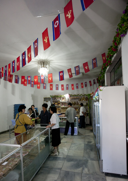 North Korean shop decorated with workers' Party of North Korea and national flags, Pyongan Province, Pyongyang, North Korea