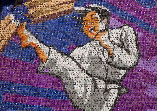 Taekwondo fighter made by children pixels holding up colored boards during Arirang mass games in may day stadium, Pyongan Province, Pyongyang, North Korea