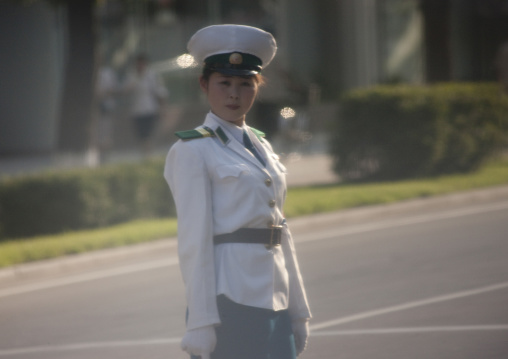 North Korean female traffic security officer in white uniform in the street, Pyongan Province, Pyongyang, North Korea