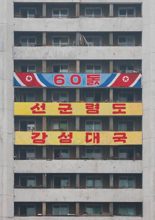 Billboard for the 60th anniversary of the regim on a building saying songun keadership powerful and prosperous country, Pyongan Province, Pyongyang, North Korea