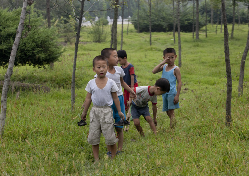 North Korean skinny boys playing in a park, Pyongan Province, Pyongyang, North Korea
