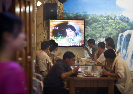 North Korean people in a luxury restaurant in front of a karaoke television, Pyongan Province, Pyongyang, North Korea