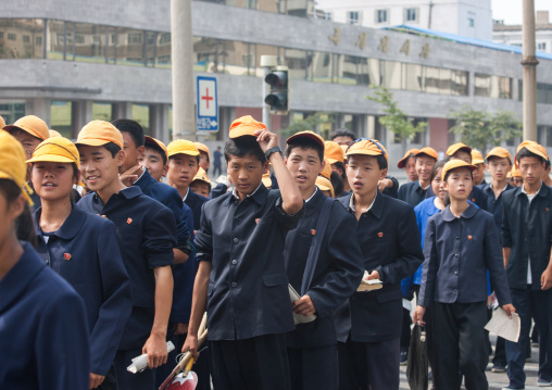 North Korean teenagers with yellow caps during the celebration of the 60th anniversary of the regim, Pyongan Province, Pyongyang, North Korea