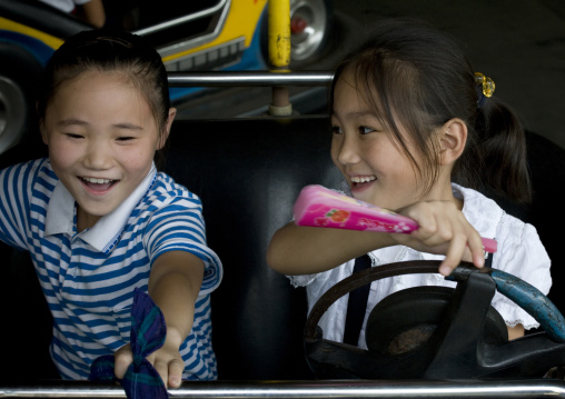 North Korean girls in bumpers cars in Taesongsan funfair, Pyongan Province, Pyongyang, North Korea