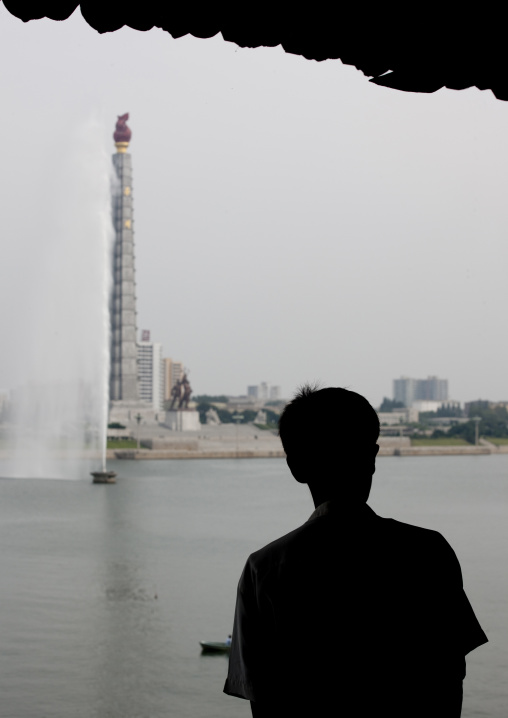 North Korean man silhouette in front of the Juche tower, Pyongan Province, Pyongyang, North Korea