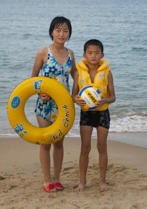 North Korean children on a beach with rubber ring and ball, North Hamgyong Province, Chilbo Sea, North Korea